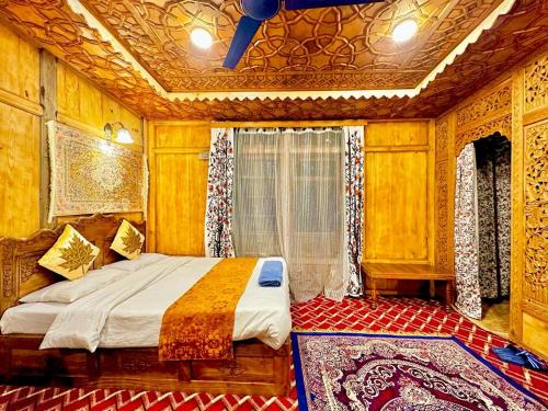a bedroom with a bed in a room with wooden walls at The Hayat Group Of Houseboats in Srinagar