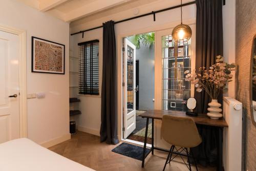 a dining room with a table and a window at B&B Felix in Amsterdam