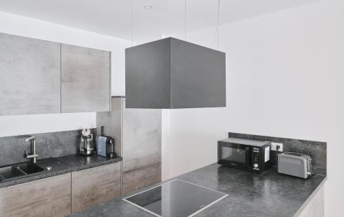 a kitchen with a sink and a microwave at Wohnen in Wattens Top 2 in Wattens