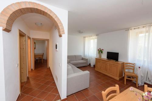 a living room with a couch and a tv in it at Agritur La Pieve in Taio