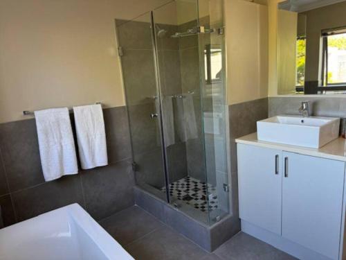 a bathroom with a shower and a sink at Luxury Townhouse in Stellenbosch CENTRAL (BACK-UP POWER) in Stellenbosch