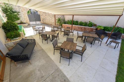 an outdoor patio with tables and chairs at Agritur La Pieve in Taio