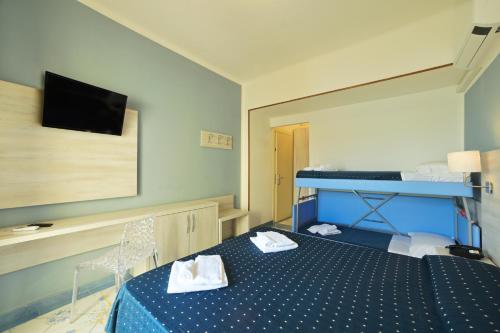 Postel nebo postele na pokoji v ubytování Hotel Delfino