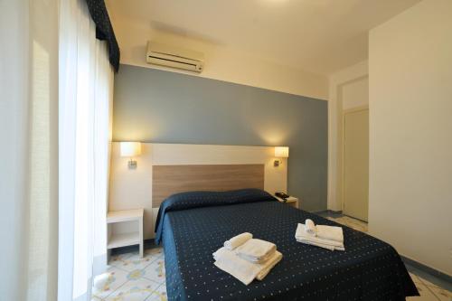Postel nebo postele na pokoji v ubytování Hotel Delfino