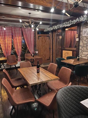 a restaurant with tables and chairs in a room at Camp Hotel Lake Views in Plav