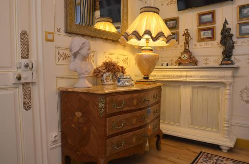 een lamp op een dressoir in een kamer bij La Maison de l'Argentier du Roy in Loches