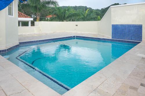 a swimming pool with blue water in a house at Lawson Rock - Angelfish 201 condo in Roatan