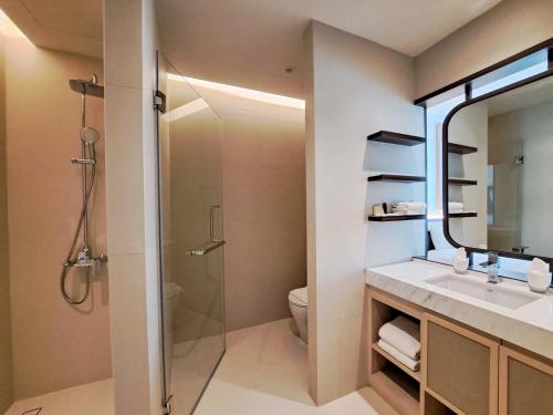 a bathroom with a shower and a sink and a mirror at Estella Khao Yai in Khao Yai