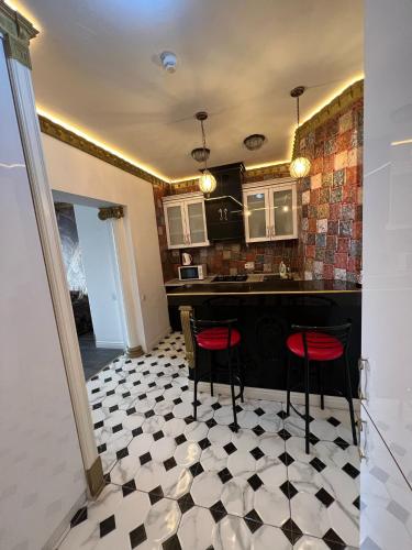 a kitchen with a black and white checkered floor at Chisinau Central Park in Chişinău