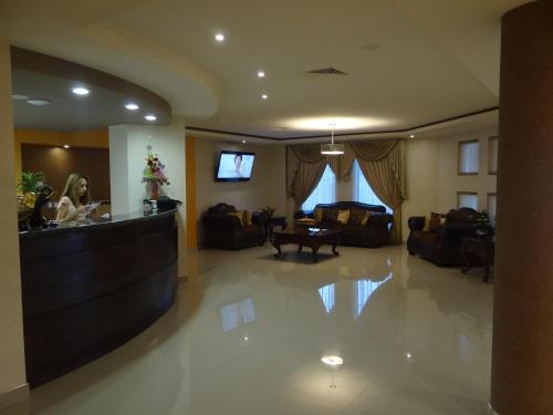 a lobby with a bar in the middle of a room at Hotel Don Ruben in Chihuahua