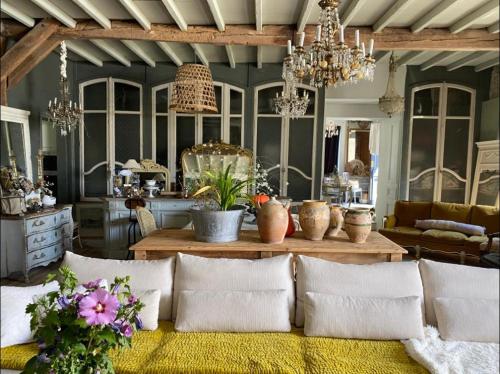 a living room with a couch and a table with vases at Maison de Vacances avec Piscine Privée en Dordogne in Boisse