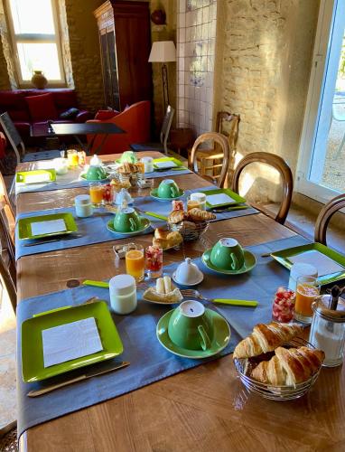 a long table with food and bread on it at Le Mas Carré Séguret in Séguret