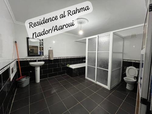 a bathroom with a toilet and a sink at Residence al Rahma nr 01 in Monte ʼArrouit