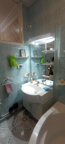 a bathroom with a white sink and a toilet at Jolie Maison au centre de Sidi Bou Said in Sidi Bou Saïd