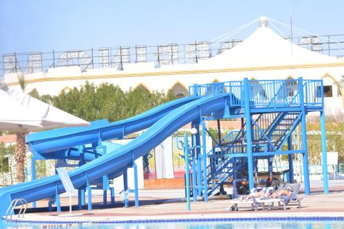 a blue water slide in a swimming pool at Sharm Cliff Hotel in Sharm El Sheikh