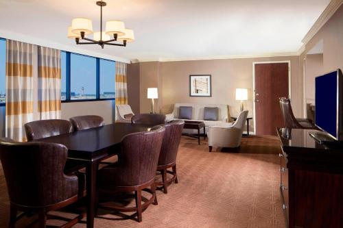 a living room with a dining room table and chairs at Sheraton DFW Airport Hotel in Irving