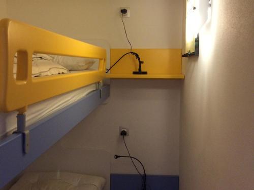 a bedroom with a yellow bunk bed in a room at Appartement Montgenèvre, 3 pièces, 4 personnes - FR-1-445-28 in Montgenèvre