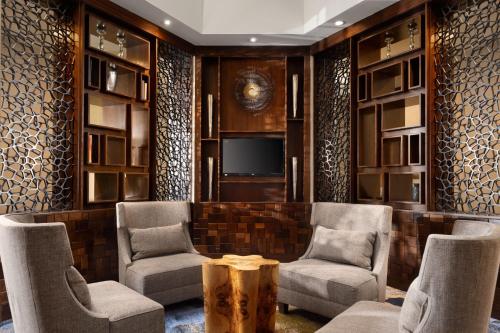 a lobby with chairs and a tv and a table at Delta Hotels by Marriott Philadelphia Airport in Philadelphia