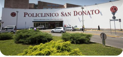 a building with cars parked in a parking lot at ROYAL MILANO LINATE APARTMENTS in Pantigliate