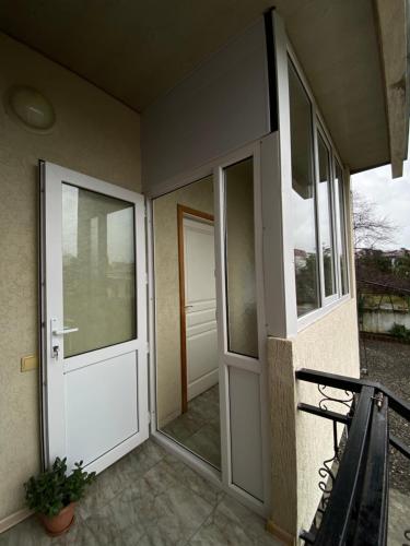 an entrance to a house with two glass doors at Apartment on Lado Asatiani in Batumi