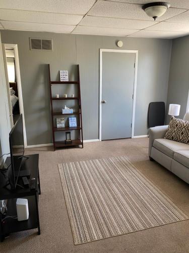 a living room with a couch and a door at Downtown Getaway in Michigan City