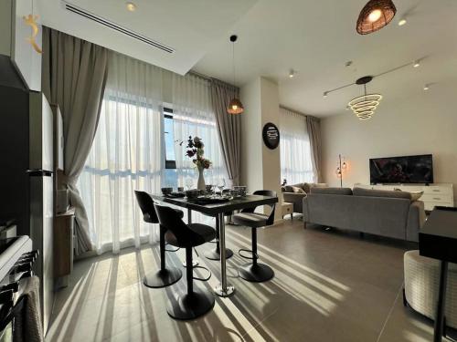 a living room with a table and chairs and a couch at Al Reem Skyline 1BR - Stylish Luxe Retreat in Abu Dhabi