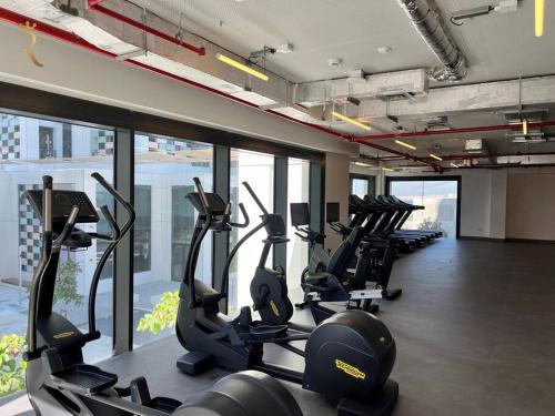 a gym with treadmills and ellipticals in a building at Al Reem Skyline 1BR - Stylish Luxe Retreat in Abu Dhabi