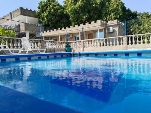 a swimming pool with blue water in front of a building at SGH Castillo Aqua in Santa Marta