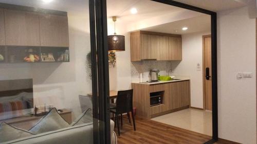 a kitchen with a table and a dining room at PoolAccess-rose Lahabana in Hua Hin