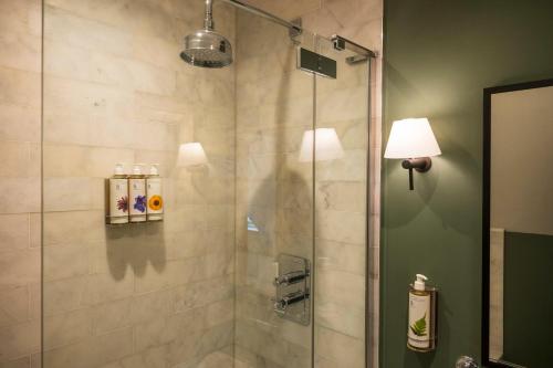 een douche met een glazen deur in de badkamer bij The Bottle & Glass Inn - Barn View - Room 2 in Henley on Thames