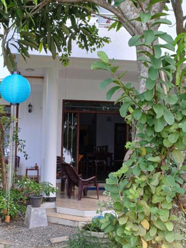 a porch of a house with a blue lamp at Villa River View in Aluthgama