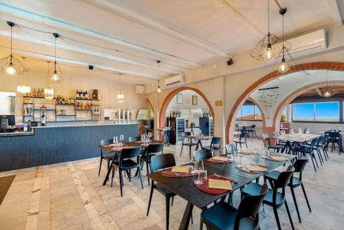 a restaurant with tables and chairs in a room at Ippotur Medieval Resort in Castelnuovo Magra