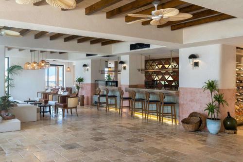 a lobby with a bar with chairs and tables at Radisson Blu Hotel, Kas in Kaş