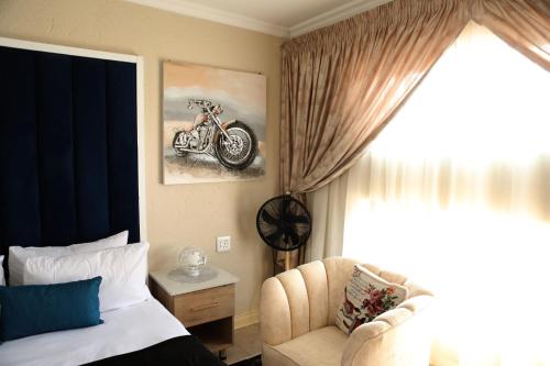 a bedroom with a bed and a motorcycle on the wall at The Edge Lodge in Polokwane