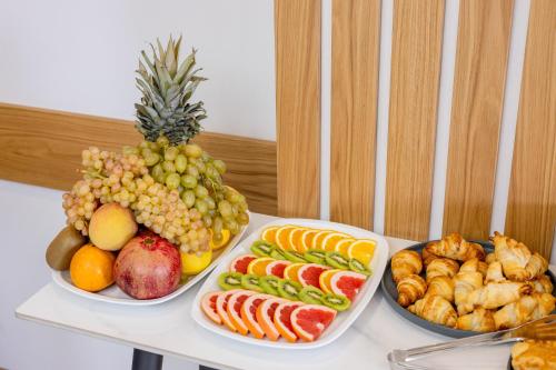 a table with three plates of fruits and vegetables at Revive Boutique Hotel in Yerevan