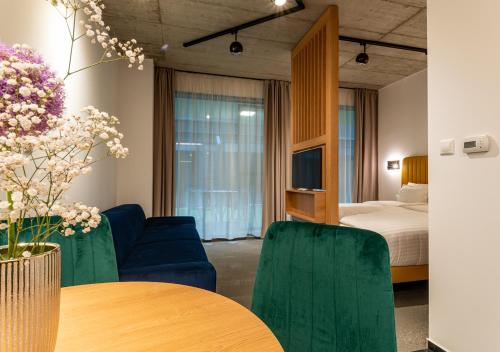 a hotel room with a bed and a table and chairs at Noir Hotel in Szeged