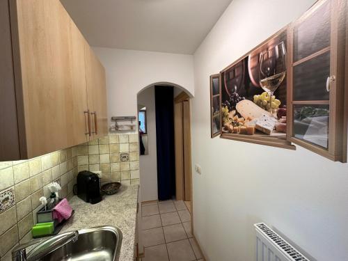 a bathroom with a sink and a counter with wine glasses at „Alte Fronfeste“ Berchtesgaden in Berchtesgaden