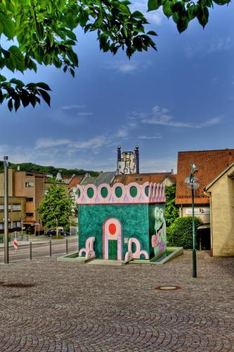 a small building with a painting on the side of it at Schurwald Hotel in Plochingen