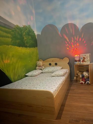 a bedroom with a bed with a teddy bear on it at Tykes Inn - Childcare and Day Hotel Exclusively for Kids in Colombo