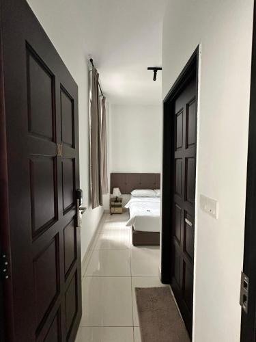 an open door to a bedroom with a bed at Lodge 43 House in George Town