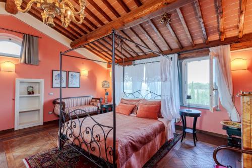 a bedroom with a bed in a room with orange walls at Villa Montefalcone: Charm, Private Pool, and Chef in Orentano