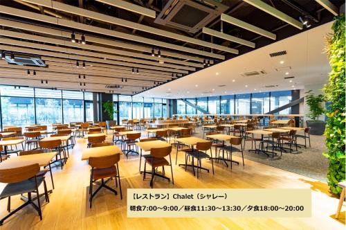a dining room with tables and chairs and windows at L stay & grow Minami Sunamachi in Tokyo