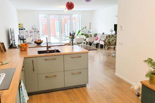 a kitchen with a sink and a counter top at Long-stay family house Meerstad in Groningen