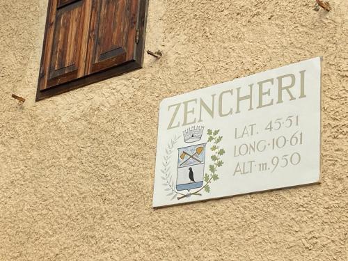 a sign on the side of a building at CIELO E TERRA Chalet Zencheri con vista panoramica in Piazza