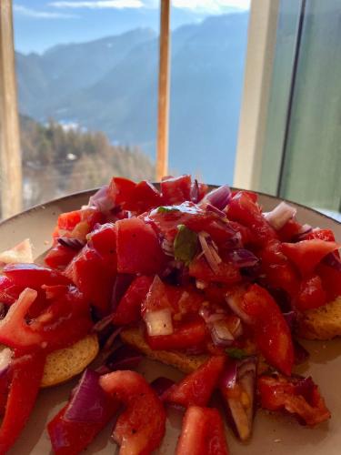 a plate of food with strawberries on a table at CIELO E TERRA Chalet Zencheri con vista panoramica in Piazza