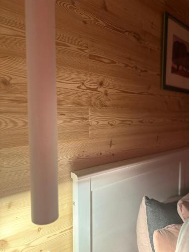 a room with a wooden wall and a column at CIELO E TERRA Chalet Zencheri con vista panoramica in Piazza
