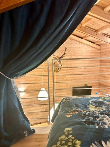 a bedroom with a bed with a black curtain at CIELO E TERRA Chalet Zencheri con vista panoramica in Piazza