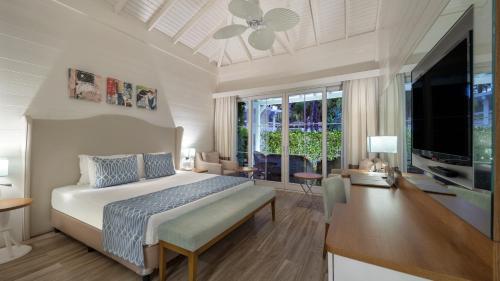 a bedroom with a bed and a desk and a television at Nirvana Mediterranean Excellence - Ultra All Inclusive in Beldibi