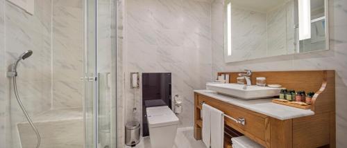 a bathroom with a shower and a sink and a toilet at Nirvana Mediterranean Excellence - Ultra All Inclusive in Beldibi