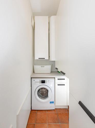 a laundry room with a washer and dryer at CitySuite Lienz in Lienz
